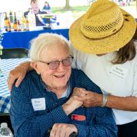 Becky Eckstrom '80 hugging president Don Lubbers in greeting